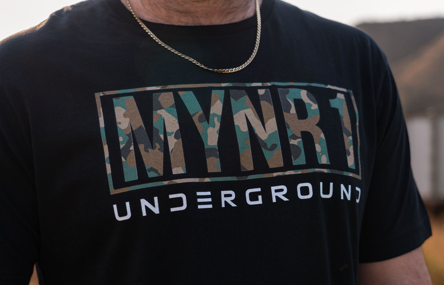 Black MYNR1 Underground logo with camo and white text. Unisex crewneck made from 100% Cotton and combined and ring-spun cotton. Machine wash cold, wash inside out. Comes in XS-XXXL