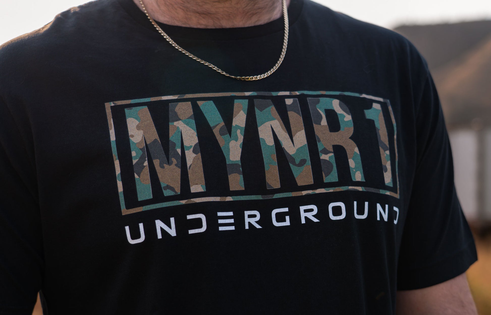 Black MYNR1 Underground logo with camo and white text.  Unisex crewneck made from 100% Cotton and combined and ring-spun cotton.  Machine wash cold, wash inside out.  Comes in XS-XXXL
